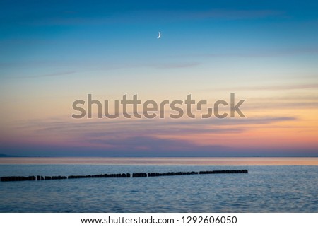 The crescent moon on the evening sky at the Baltic Sea of Germany