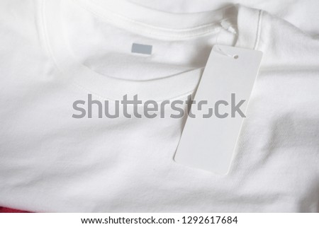 Blank price tag label on white t-shirt