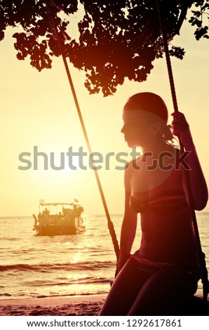 Silhouettes on the beach in the setting sun on Samet Island, Thailand