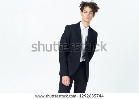 Business guy with curly hair and in a suit                       