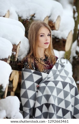Beautiful young woman in winter forest
