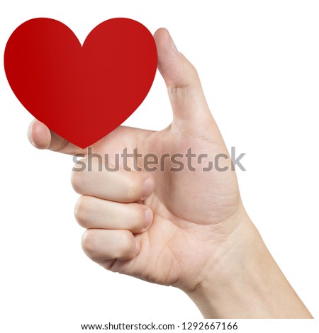 Hand holding a small red heart, isolated on white background