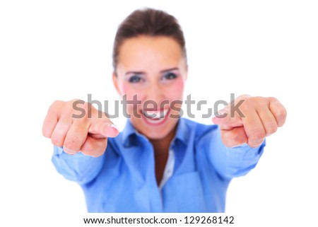 A picture of a young happy woman pointing at something over white background