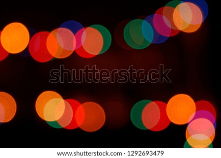 Festive street illumination glittering in darkness. Blurred holiday garland lighting for Chinese New Year. Natural classic bokeh background. Night photo with black copy space for text or logo.