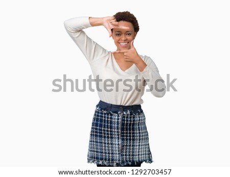 Young african american woman over isolated background smiling making frame with hands and fingers with happy face. Creativity and photography concept.