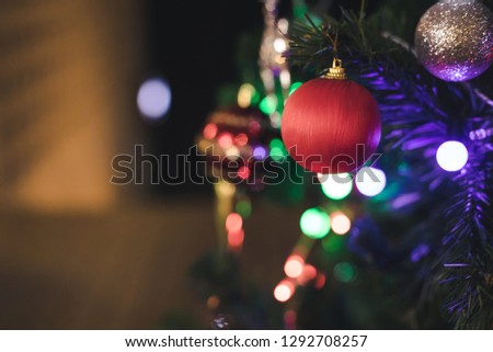 close up of red ball hanging on Christmas tree as a prop with led light line