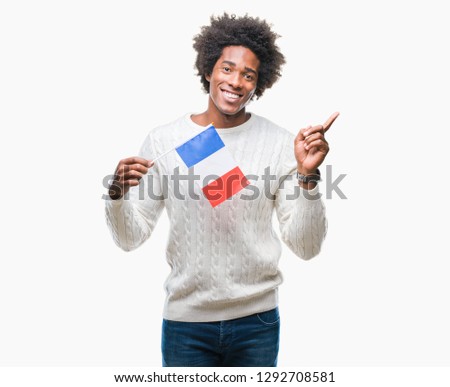 Afro american man flag of France over isolated background very happy pointing with hand and finger to the side