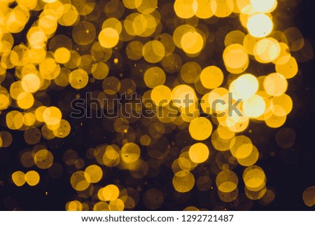 Abstract gold defocused bokeh of lights in dark background