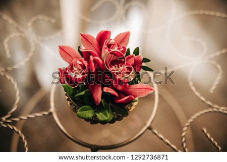 wedding rings lie on delicate red flowers