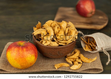 Apple slices, dried, in a ceramic bowl close-up