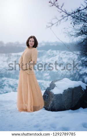 girl with a golden dress in a snowy photo shoot