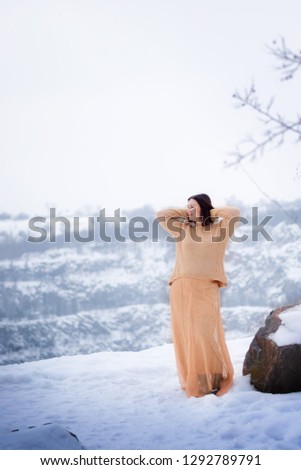 girl with a golden dress in a snowy photo shoot