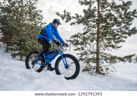 Fat tire bike. A young man riding fat bicycle in the winter