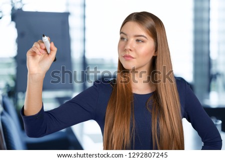 Businesswoman write on a glass board