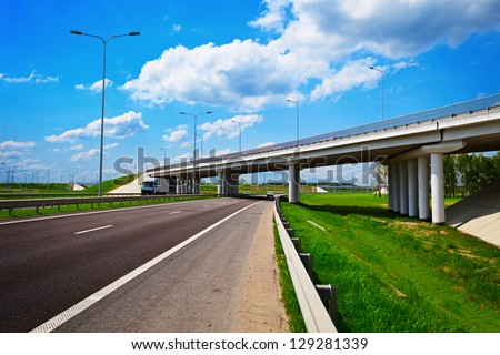 Road under construction. Freeway, overpass and junction with green grass