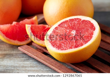 Fresh raw grapefruit (citrus x paradisi) on wooden background Royalty-Free Stock Photo #1292867065
