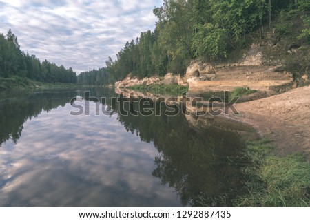red sandstone cliffs with tourist trail on river of gauja, Latvia in summer - vintage retro look