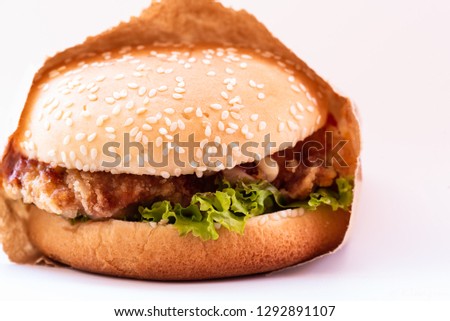 Close up chicken burger on white background and space copy.Fast food for breakfast.Junk food or unhealthy food concept.
