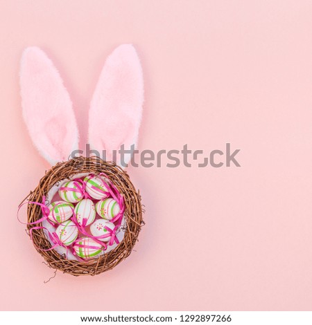 Creative Top view flat lay holiday composition Easter eggs bunny ears spring flowers on pink paper background copy space Template Easter day seasonal pattern