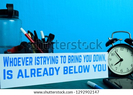 Whoever is trying to bring you down, Is already below you Planning on Background of Working Table with Office Supplies. Business Concept Planning on Blue Background