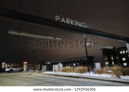 Parking ramp entrance with overhead sign                             