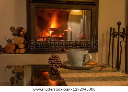 romantic scene with a mug and a fireplace