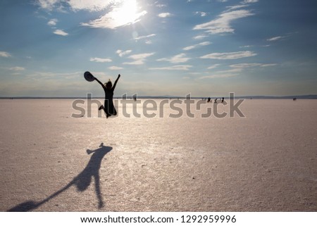 young girl jumping on the salt lake