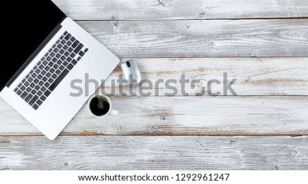 Overhead view of desktop with computer mouse and coffee plus plenty of copy space 