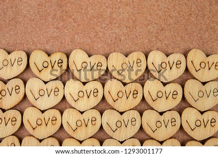 Many wooden natural hearts with an inscription love