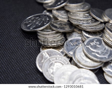 Pile of Icelandic Krona coins on color background
