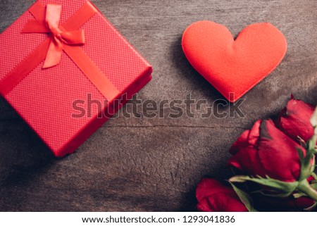 Red hearts, flower roses and gift box on wooden background, valentine day concept