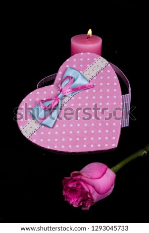 Rose and present  gift boxes on black background,Valentines day background.
Valentines Day gift in red box with rose