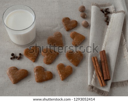 The glass of the milk with handmade cakes on the plate and with serviettes with allspices on the natural tablecloth This picture have made by middleformat camera.jpg