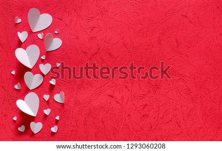 WHITE HEARTS OF PAPER ON RED TEXTURED BACKGROUND FOR HAPPY SAN VALENTINE DAY
