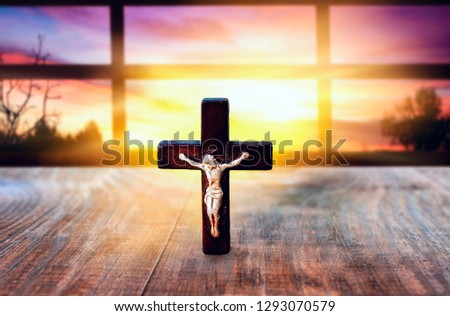 Christian cross on sunset background . Way to God . bright light from heaven . Religious background