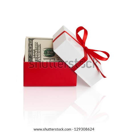 U.S. dollars banknotes laying in red bow decorated gift box.