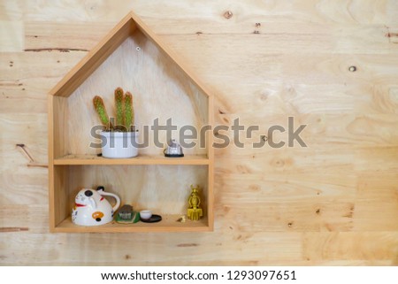 House wooden shelves on wooden wall with vase and accessories.