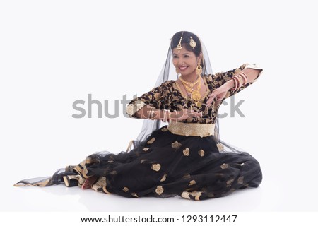 Young lady performing traditional dance of India called Mujra