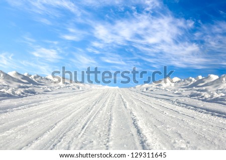 snowy road in the countryside Royalty-Free Stock Photo #129311645