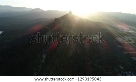 Aerial view of Bukit Tabur hill during sunrise hour.  Tropical sunrise at Tabur hill show the golden light behind the hill slope.