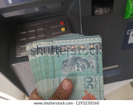 Hand showing 50 Ringgit Malaysia (MYR) money

