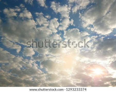 Blue sky and sunshine with dark clouds for background or graphic design