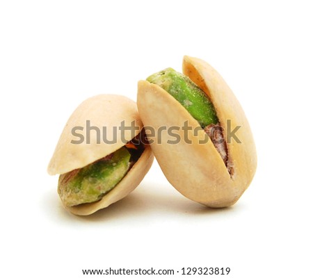 toasted pistachios on a white background Royalty-Free Stock Photo #129323819