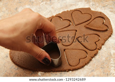 Cookie dough in the shape of hearts. This image can be used to represent baking for Valentines day. 
