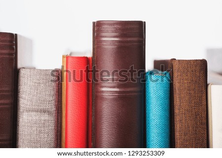 multi-colored albums of different sizes and textures on a white background