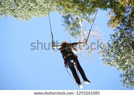 Extreme sportsman jumps on a rope.          