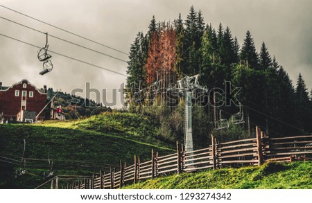 Landscape of summer mountains with forested slopes and chair lift. Travel background