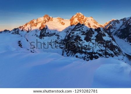 Stunning view of Mont Blanc massif and his melting glaciers. Winter adventures in the Italian French Alps. 
Courmayeur, Aosta Valley. Italy
Val Veny, and the ski slopes of the Courmayeur ski domain.