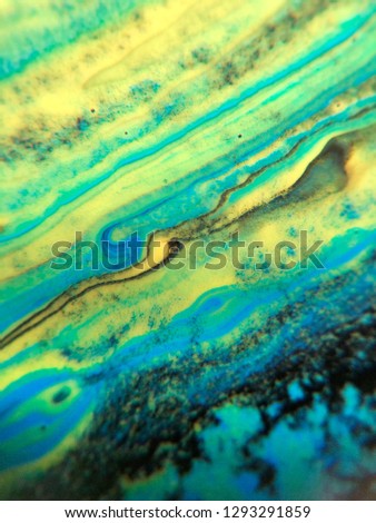 Blue, green and yellow colored abstract paint background texture.