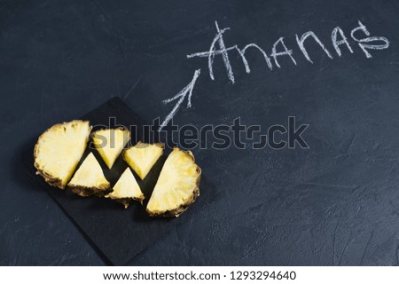 Pineapple slices on a chalkboard, inscription in chalk pineapple